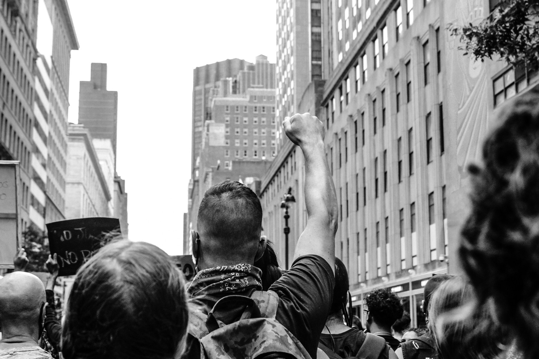 Unrecognizable rebellious strikers protesting on city street